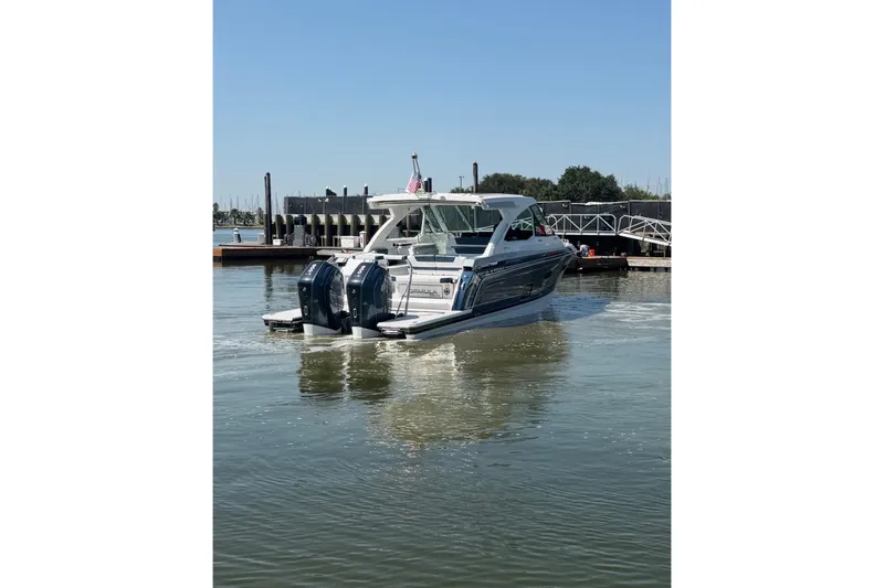 Slide: The Image of 2026 Formula 380 Super Sport Crossover OB boat docked in a marina. - 4