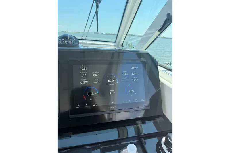Slide: The Image of Dashboard of 2026 Formula 380 Super Sport Crossover OB with Garmin display on water. - 42