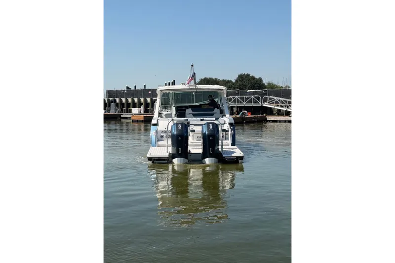 Slide: The Image of 2026 Formula 380 Super Sport Crossover OB boat docked on calm water. - 5
