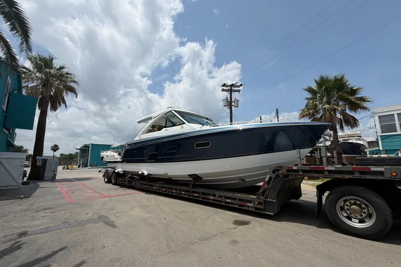 Slide: The Image of 2026 Formula 380 Super Sport Crossover OB on trailer under cloudy sky. - 7