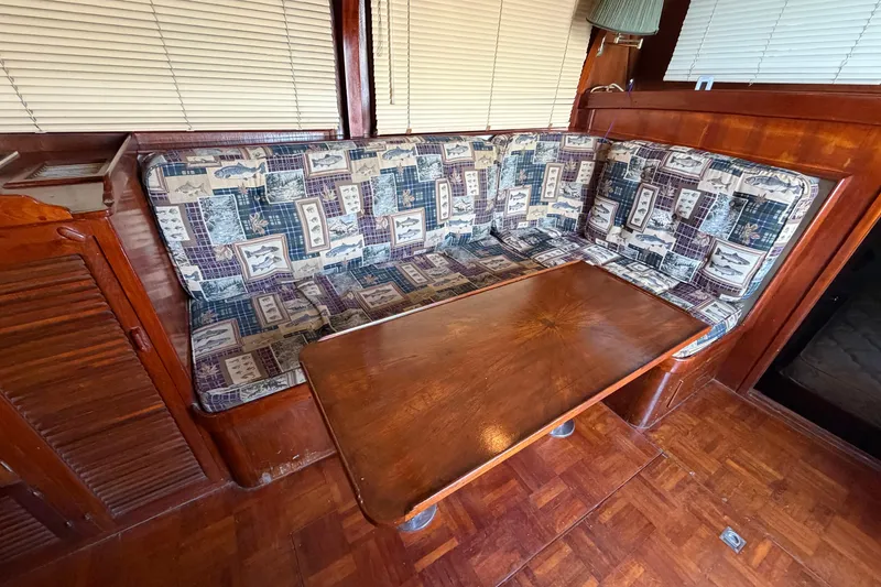 Slide: The Image of Interior of 1978 Albin 36 Trawler with patterned seating and wooden table. - 14