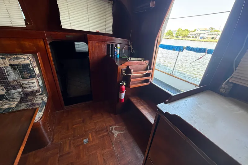 Slide: The Image of Interior of 1978 Albin 36 Trawler with wood paneling and river view. - 15