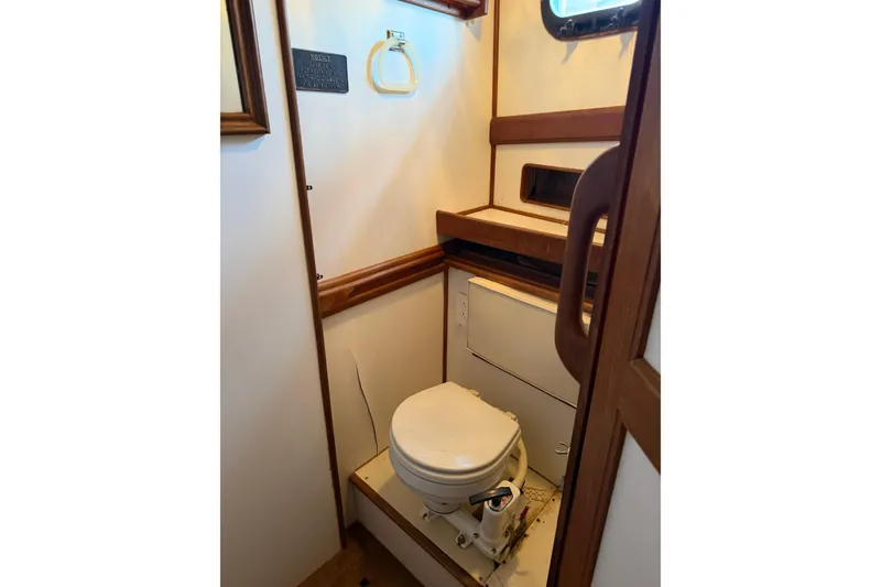 Slide: The Image of 1978 Albin 36 Trawler bathroom with wooden accents and compact marine toilet. - 20