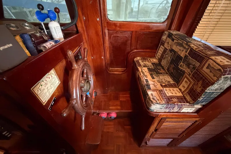 Slide: The Image of Interior of 1978 Albin 36 Trawler with wooden helm and patterned seating. - 22