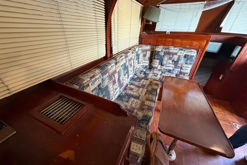 Slide: The Image of Interior of 1978 Albin 36 Trawler with patterned seating and wooden table. - 23