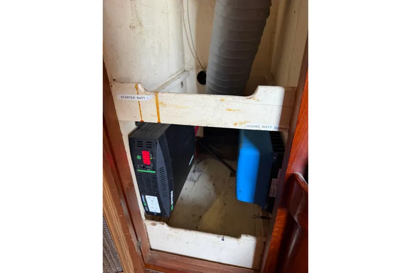 Slide: The Image of Electrical components inside a 1978 Albin 36 Trawler, featuring battery banks and wiring. - 26