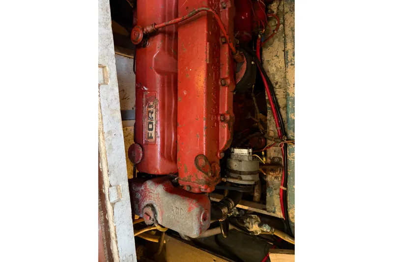 Slide: The Image of Engine of a 1978 Albin 36 Trawler, featuring a red Ford Lehman diesel motor. - 32