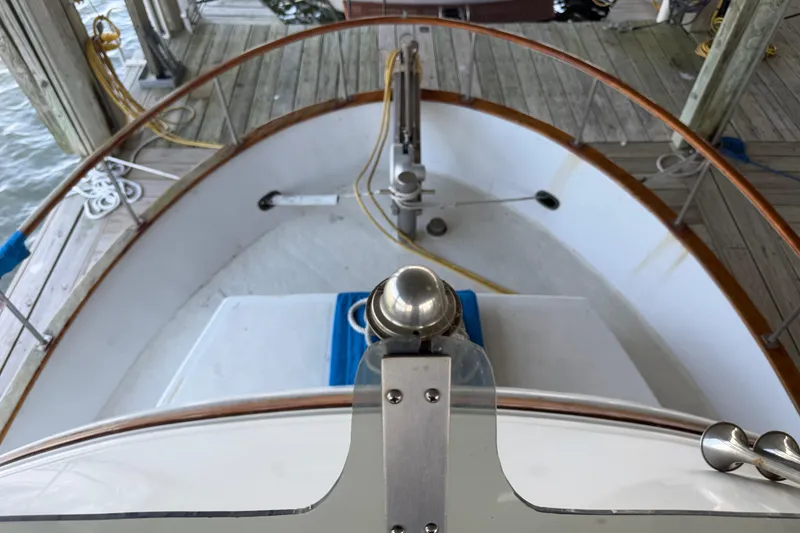 Slide: The Image of 1978 Albin 36 Trawler bow view at dock, showcasing deck and railing details. - 7