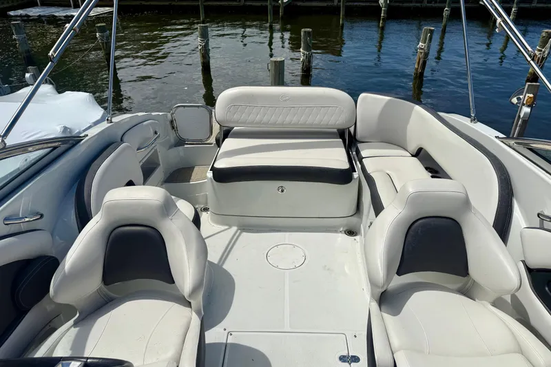 Slide: The Image of 2020 Crownline Eclipse E235 boat interior with white seating and water view. - 10