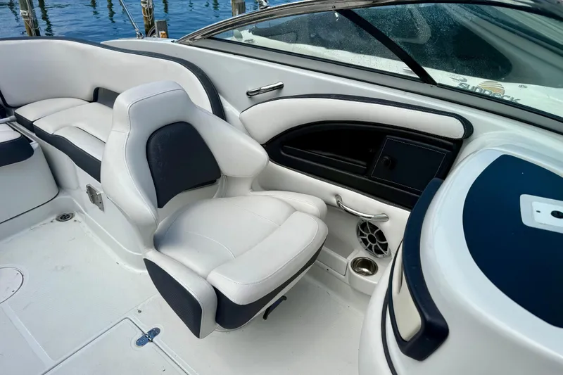 Slide: The Image of Interior of a 2020 Crownline Eclipse E235 boat, featuring sleek white seating. - 12