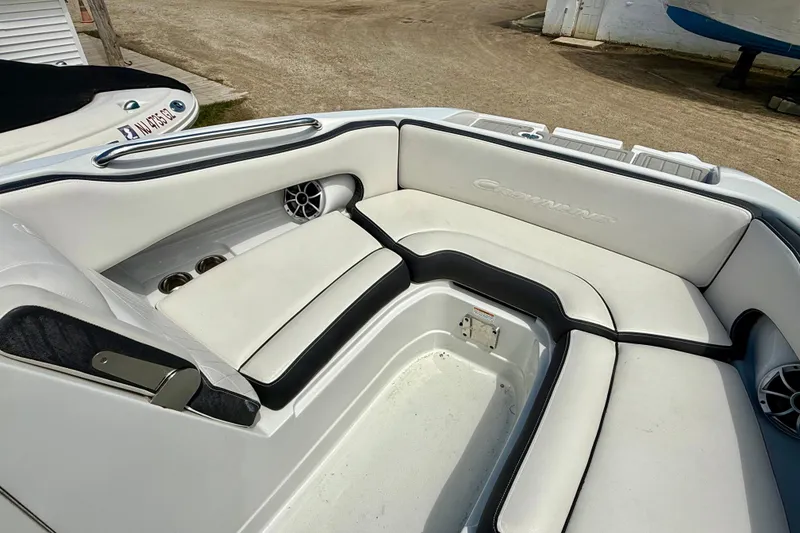Slide: The Image of 2020 Crownline Eclipse E235 boat interior with white seating and cup holders. - 16