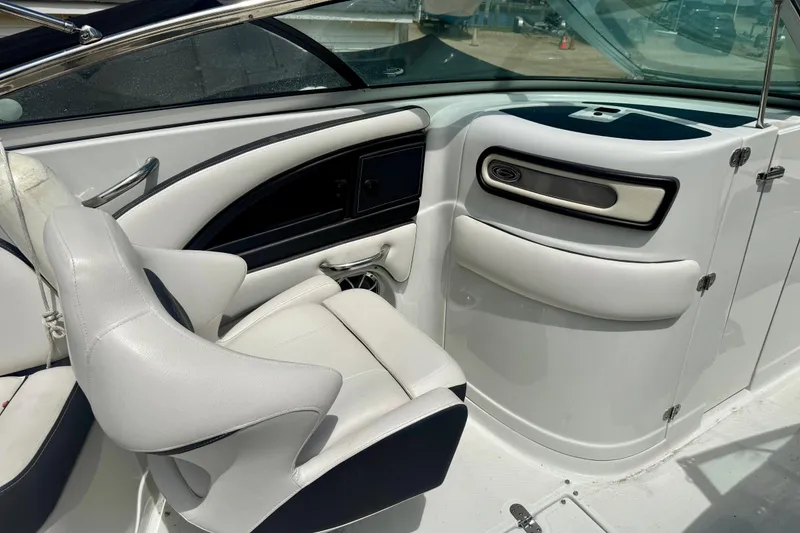 Slide: The Image of Interior of a 2020 Crownline Eclipse E235 boat, featuring sleek white seating and modern design. - 18