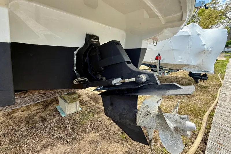 Slide: The Image of 2020 Crownline Eclipse E235 boat with Mercury outboard motor, docked on grass. - 22