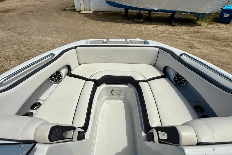 Slide: The Image of 2020 Crownline Eclipse E235 boat interior with white seating and cup holders. - 25
