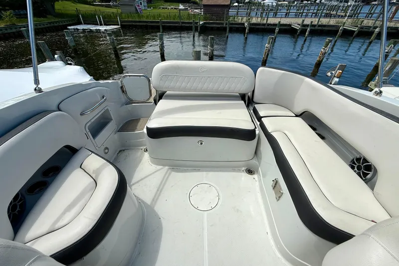 Slide: The Image of 2020 Crownline Eclipse E235 boat interior with white seating and waterfront view. - 27