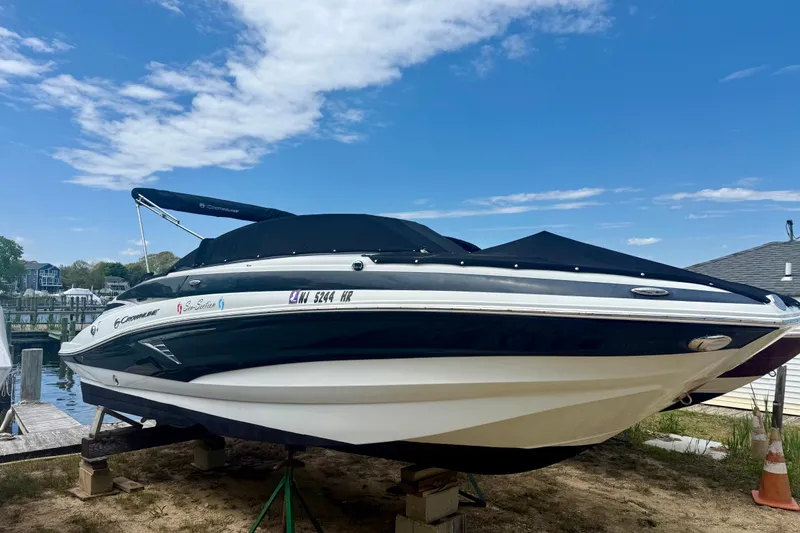 Slide: The Image of 2020 Crownline Eclipse E235 boat docked under a clear blue sky. - 3
