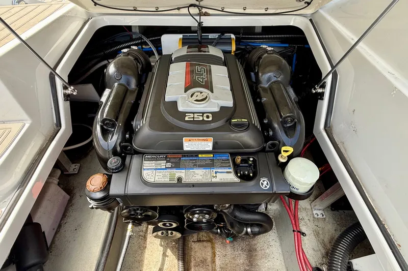 Slide: The Image of Engine compartment of a 2020 Crownline Eclipse E235 boat, featuring a Mercury 4.5L 250 engine. - 32