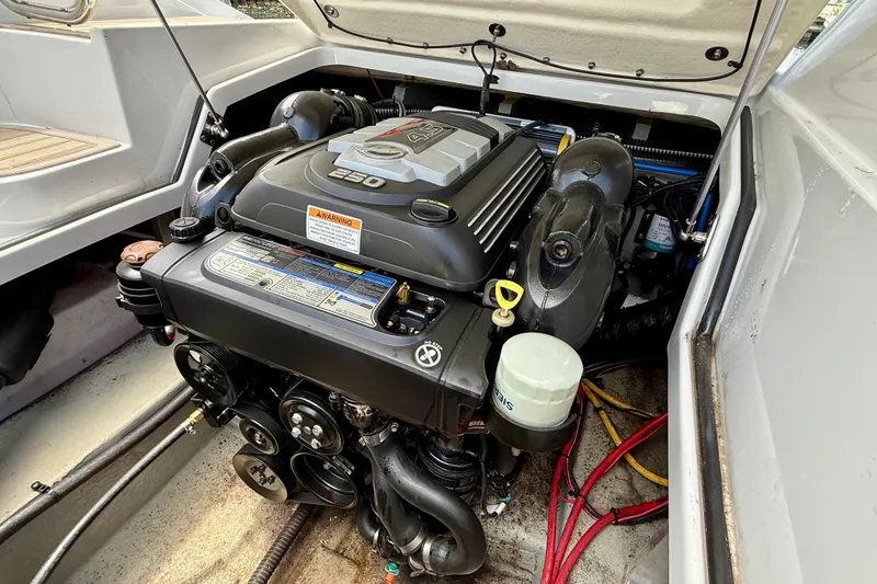 Slide: The Image of Engine compartment of a 2020 Crownline Eclipse E235 boat, showcasing a powerful motor. - 34