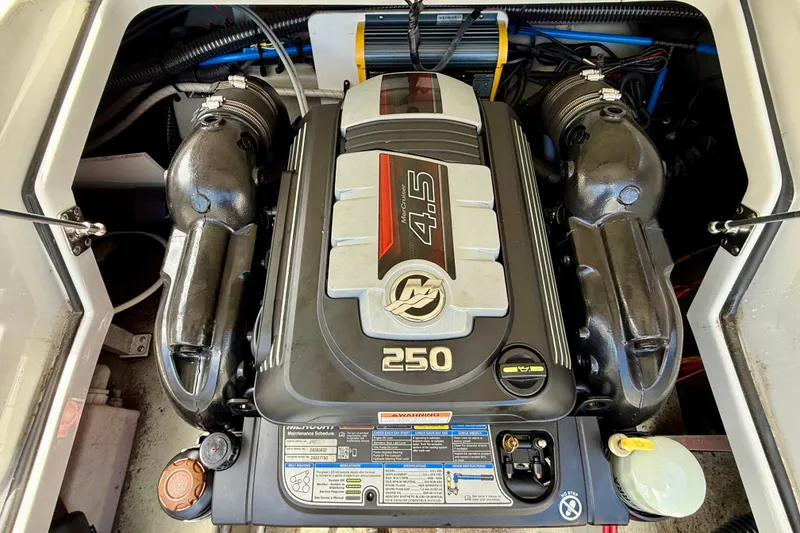 Slide: The Image of Engine compartment of a 2020 Crownline Eclipse E235 boat, featuring a 4.5L 250 HP engine. - 35