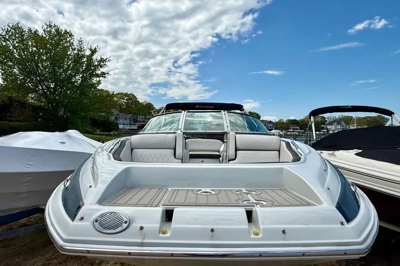Slide: The Image of 2020 Crownline Eclipse E235 boat docked under a partly cloudy sky. - 39