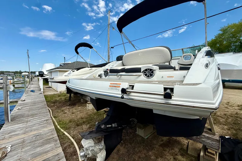 Slide: The Image of 2020 Crownline Eclipse E235 boat docked, featuring sleek design and spacious seating. - 41
