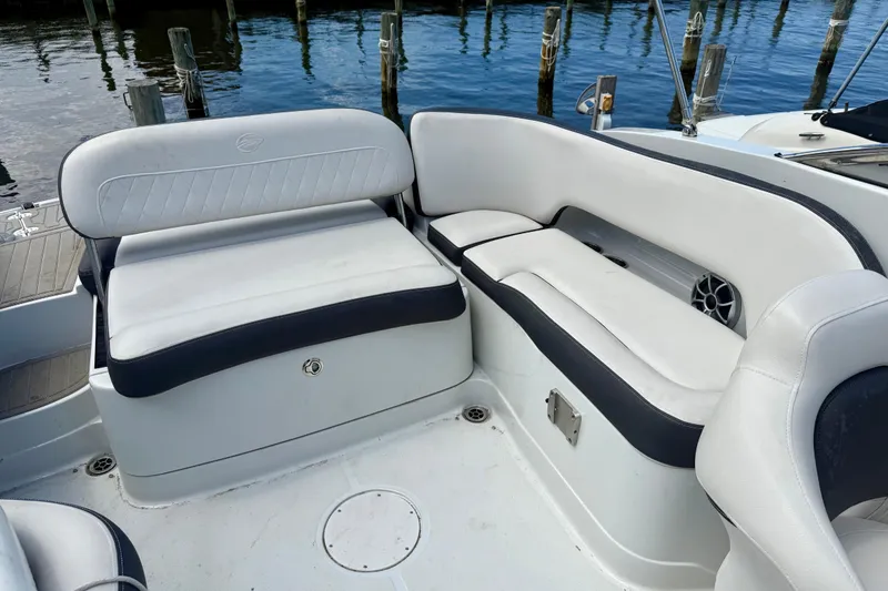 Slide: The Image of 2020 Crownline Eclipse E235 boat interior with white seating and water view. - 7