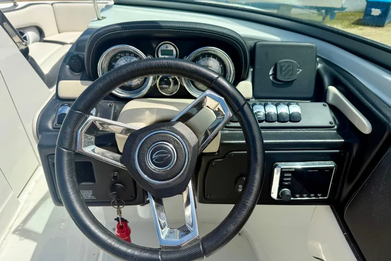 Slide: The Image of Steering wheel and dashboard of 2020 Crownline Eclipse E235 boat, featuring gauges and controls. - 9