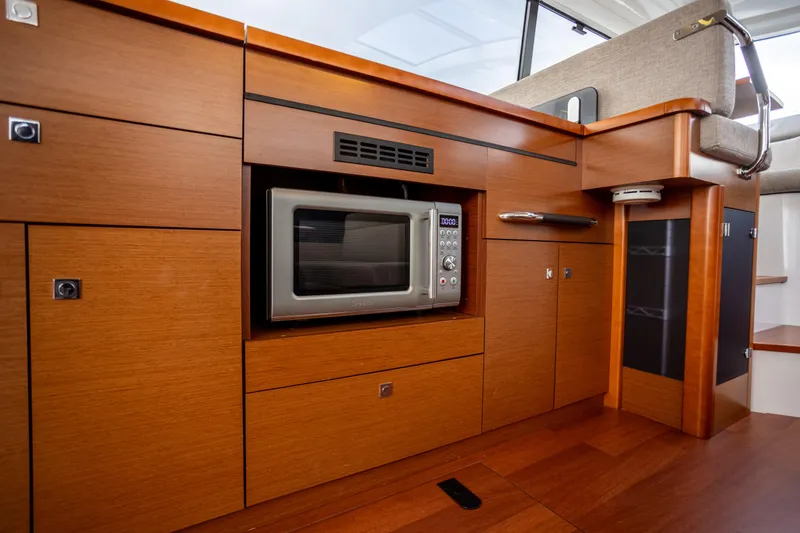 Slide: The Image of Modern kitchen area in 2017 Jeanneau NC 14 yacht with built-in microwave. - 11
