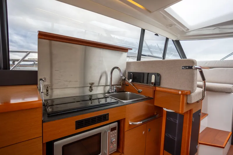 Slide: The Image of Modern kitchen area in a 2017 Jeanneau NC 14 yacht with sink and microwave. - 13