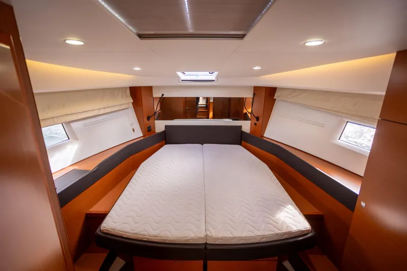 Slide: The Image of Luxurious interior cabin of 2017 Jeanneau NC 14 yacht with modern design and comfortable bedding. - 16