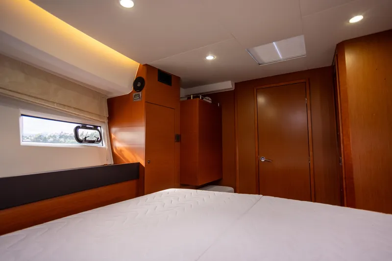 Slide: The Image of Interior cabin of 2017 Jeanneau NC 14 yacht, featuring wood paneling and modern design. - 17