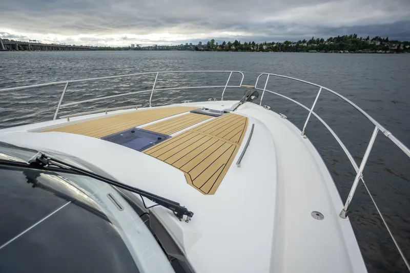 Slide: The Image of 2017 Jeanneau NC 14 yacht deck with scenic water view. - 2