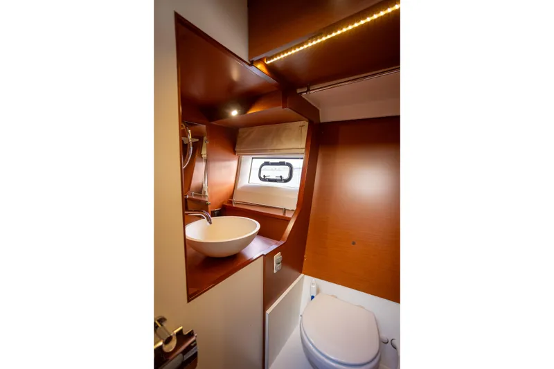 Slide: The Image of Modern bathroom interior on 2017 Jeanneau NC 14 yacht, featuring sink and toilet. - 20