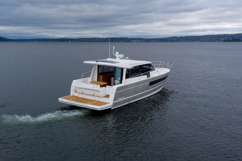 Slide: The Image of 2017 Jeanneau NC 14 yacht cruising on a calm, overcast sea. - 5