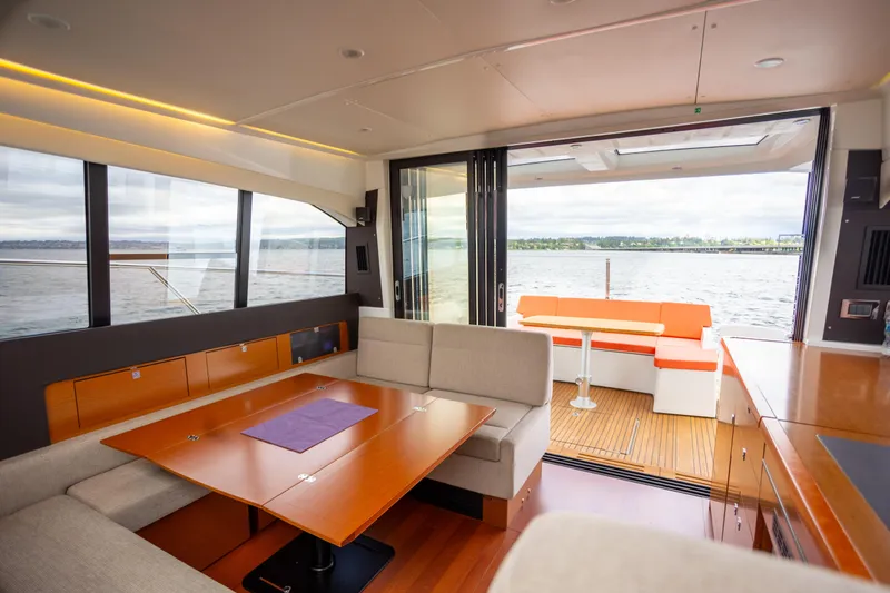 Slide: The Image of Luxurious interior of 2017 Jeanneau NC 14 yacht with spacious seating and scenic water view. - 8