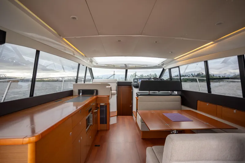 Slide: The Image of Interior of 2017 Jeanneau NC 14 yacht with modern design and panoramic windows. - 9
