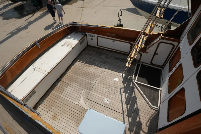 Slide: The Image of 1960 Matthews 42 Stock Cruiser with wooden deck and ladder, docked at a marina. - 10