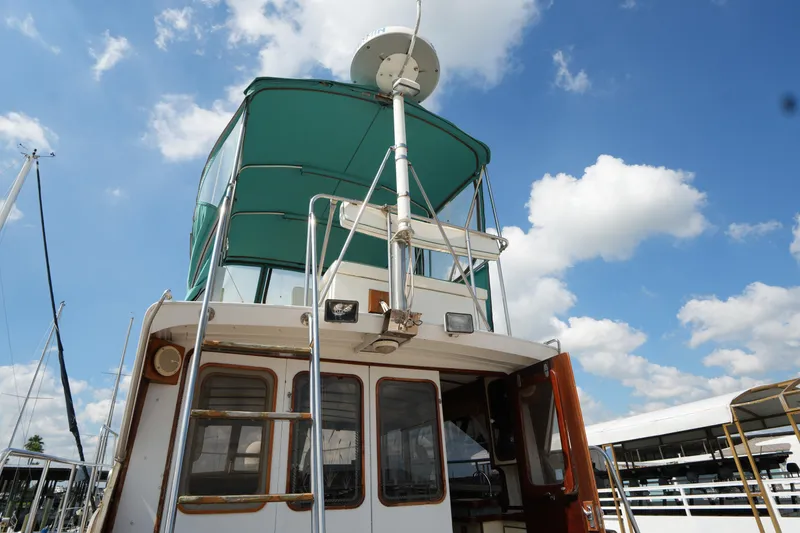 Slide: The Image of 1960 Matthews 42 Stock Cruiser with green canopy under blue sky. - 11