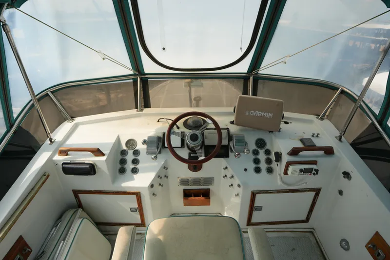 Slide: The Image of Helm of a 1960 Matthews 42 Stock Cruiser with vintage controls and modern navigation equipment. - 13