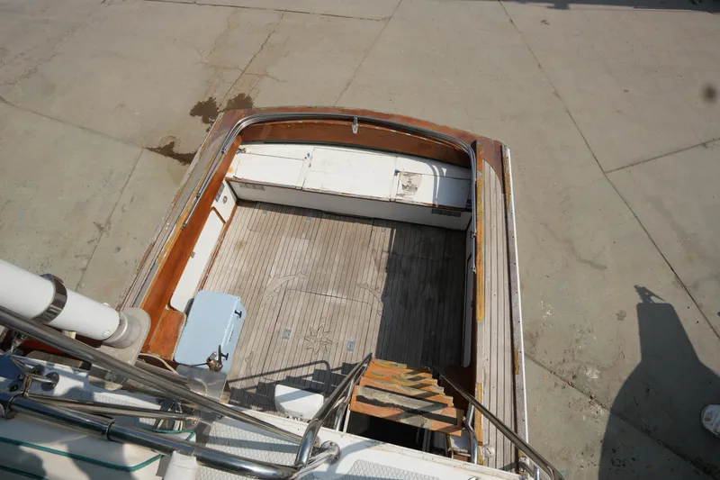 Slide: The Image of 1960 Matthews 42 Stock Cruiser boat deck with wooden flooring and metal railings. - 14
