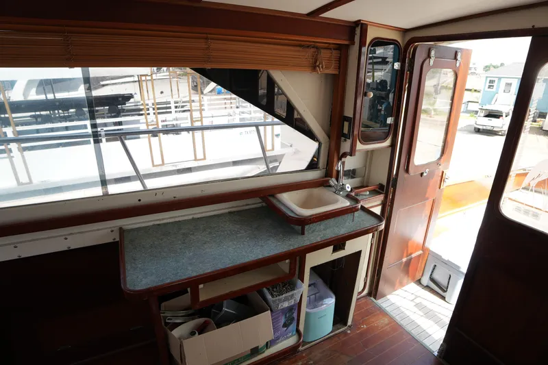Slide: The Image of Interior of a 1960 Matthews 42 Stock Cruiser with sink and wooden cabinetry. - 17