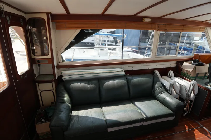 Slide: The Image of Interior of 1960 Matthews 42 Stock Cruiser with leather sofa and large windows. - 18