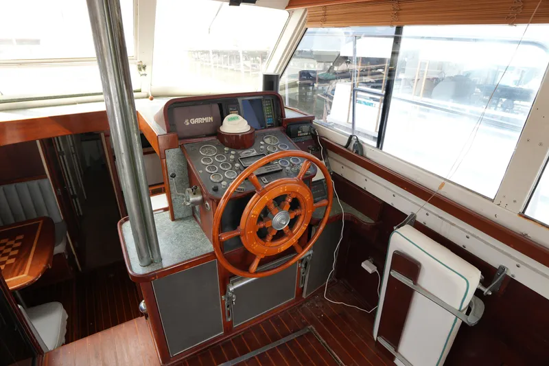 Slide: The Image of Interior helm of 1960 Matthews 42 Stock Cruiser with wooden steering wheel and navigation instruments. - 19