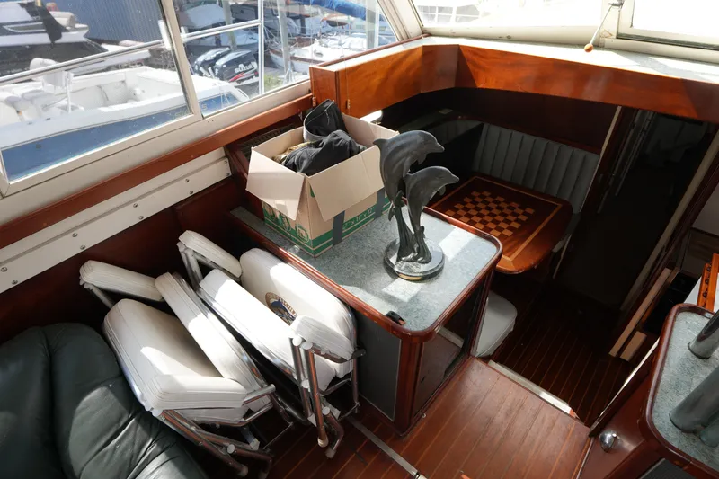 Slide: The Image of Interior of a 1960 Matthews 42 Stock Cruiser with chess table and dolphin sculpture. - 20