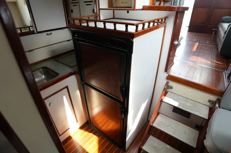 Slide: The Image of Interior of a 1960 Matthews 42 Stock Cruiser with wooden cabinetry and compact kitchen area. - 23