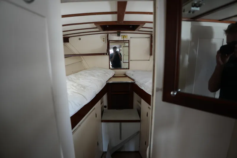 Slide: The Image of Interior of a 1960 Matthews 42 Stock Cruiser with twin beds and wooden cabinetry. - 26