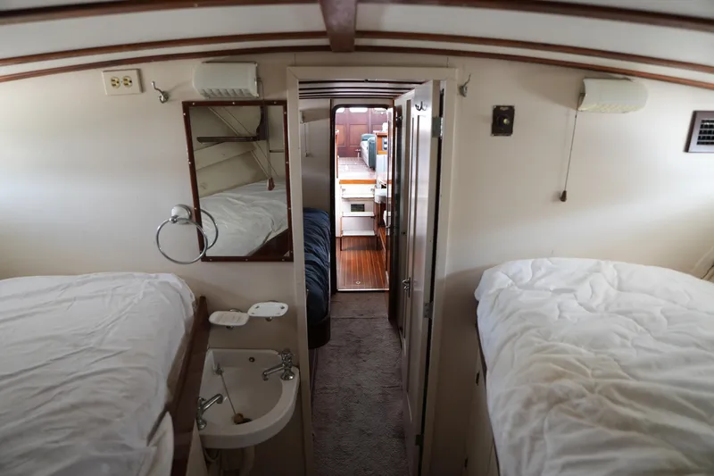 Slide: The Image of Interior of a 1960 Matthews 42 Stock Cruiser with twin beds and a compact sink. - 27