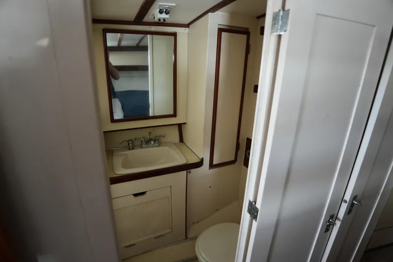 Slide: The Image of Bathroom interior of 1960 Matthews 42 Stock Cruiser with sink, mirror, and toilet. - 28