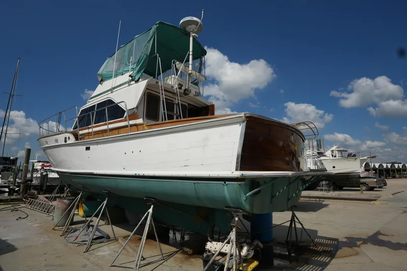 Slide: The Image of 1960 Matthews 42 Stock Cruiser on dry dock under a clear blue sky. - 4