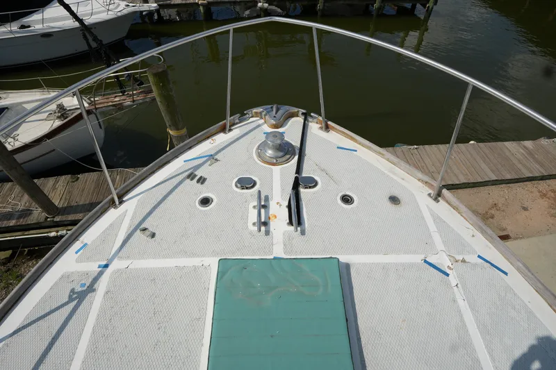 Slide: The Image of Bow view of a 1960 Matthews 42 Stock Cruiser docked at a marina. - 6